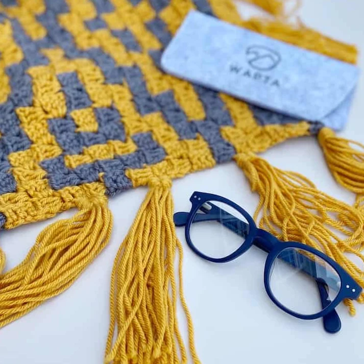 wapiti eco friendly reading glasses with crochet scarf in background